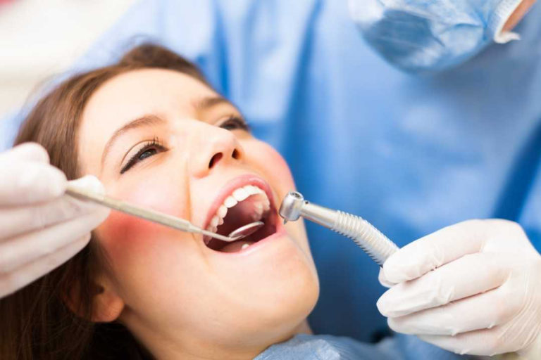 Dentist-Cleaning-Teeth-Insured-Dental-health-care